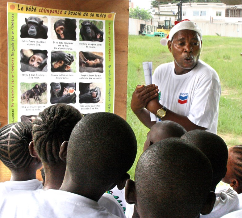 Person teaching school children about chimpanzees