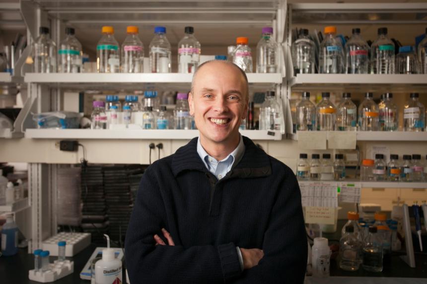 Dr. Alex Travis standing in a lab